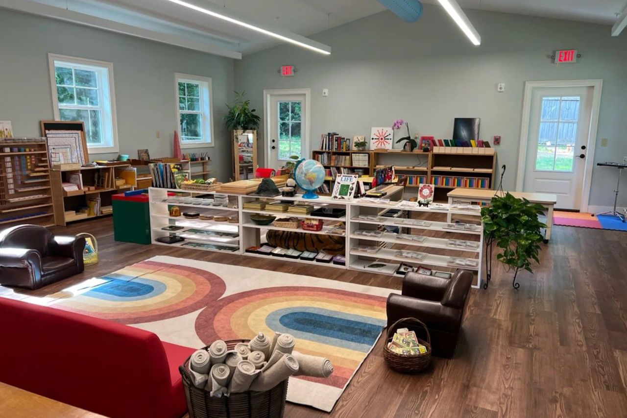Students gathered on a classroom rug during a Montessori geometry lesson